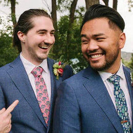 two men wearing personalized ties during a wedding