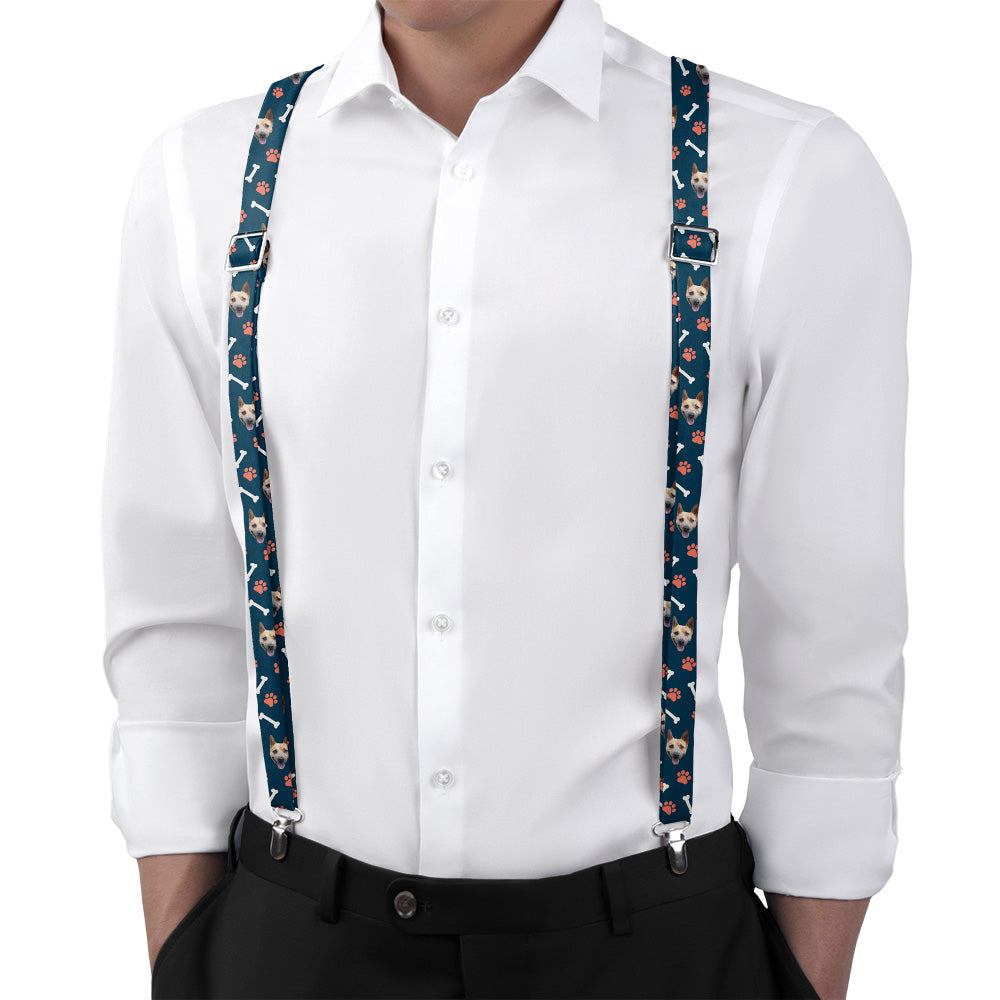 Person wearing a white shirt with floral-patterned photo suspenders on a white background