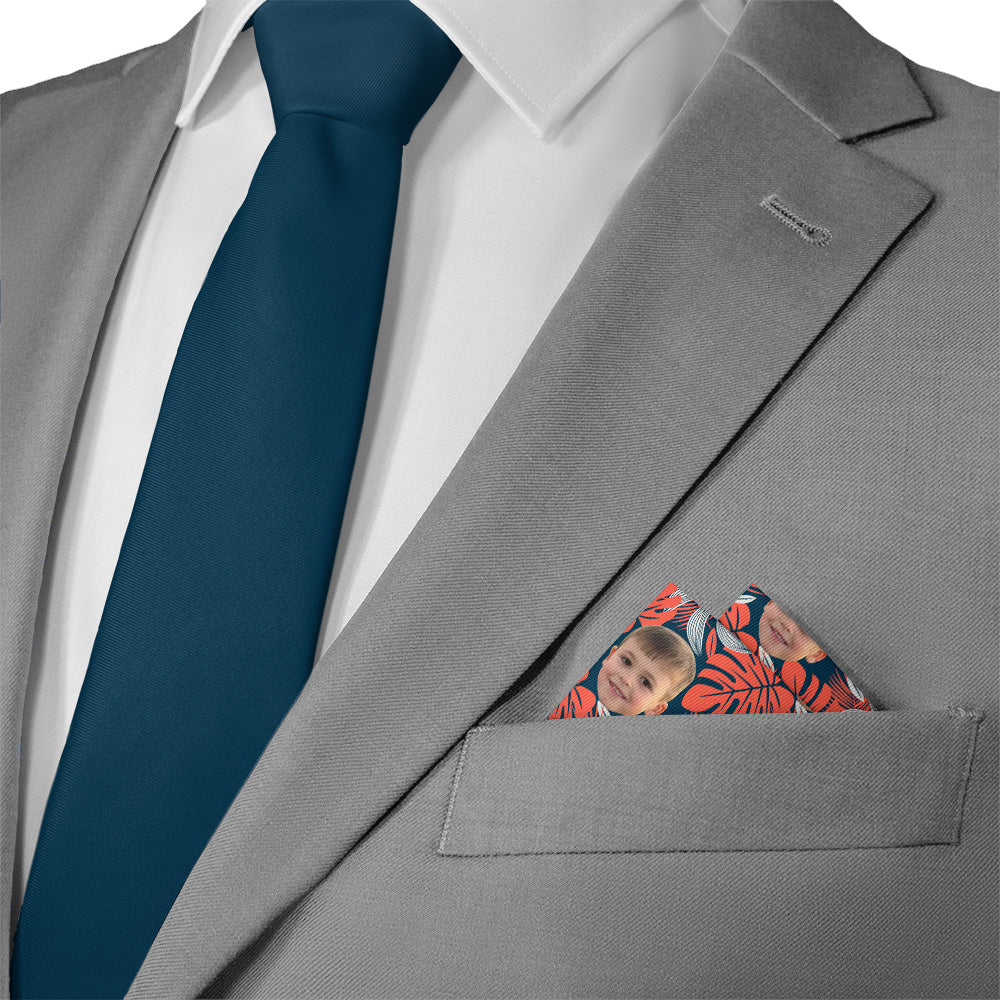 Gray suit with a blue tie and floral photo pocket square