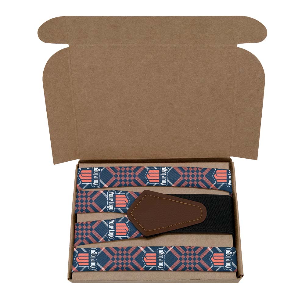 Open kraft gift box containing custom suspenders with a brand logo.