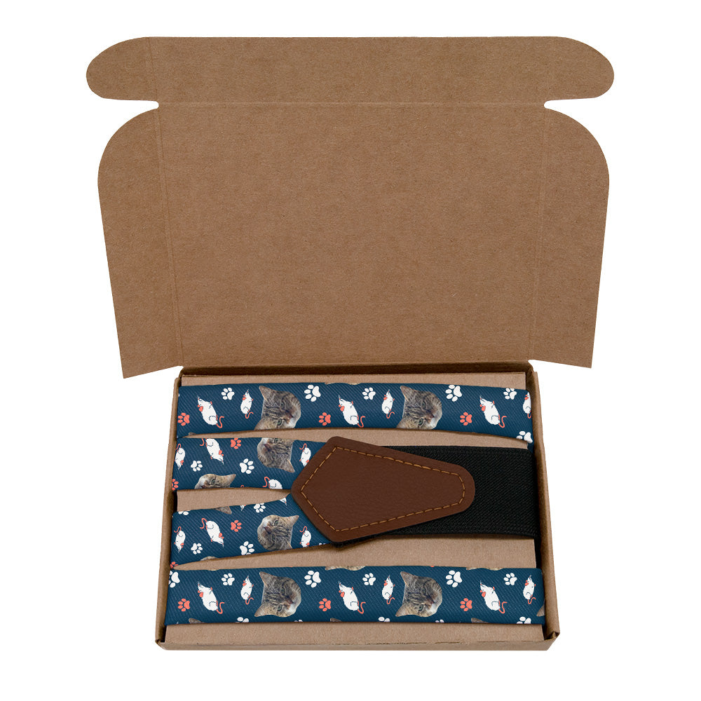 Box containing cat-themed suspenders with a blue pattern on a white background
