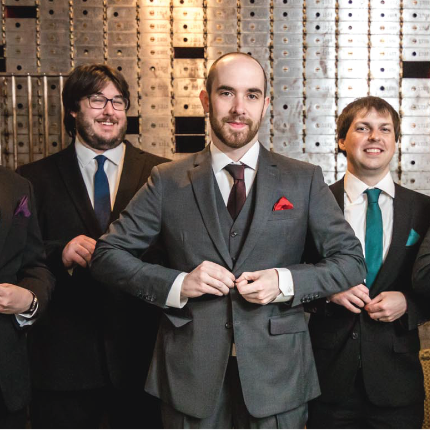 three men wearing suits and ties