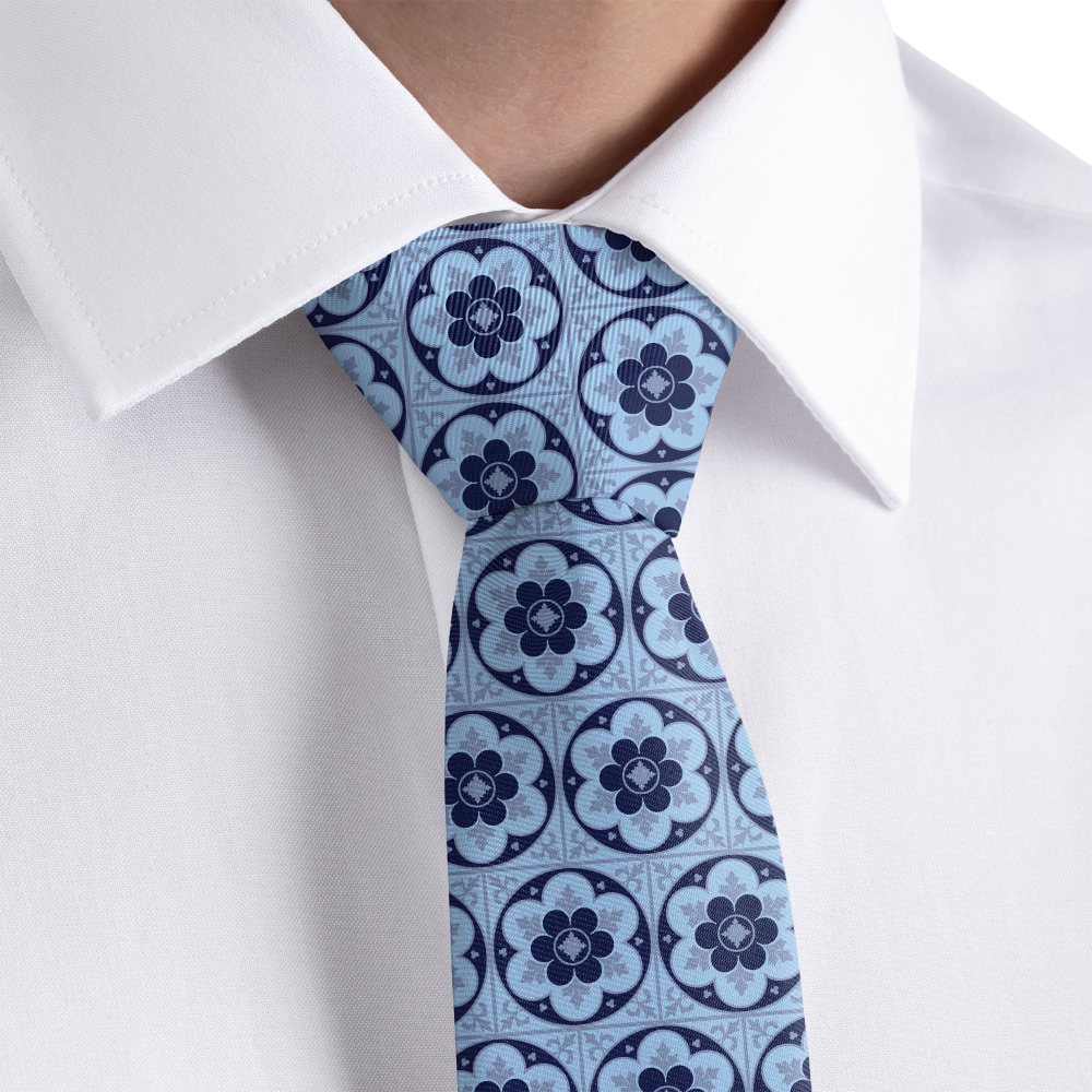 close up of an ornate pattern tie on a white shirt