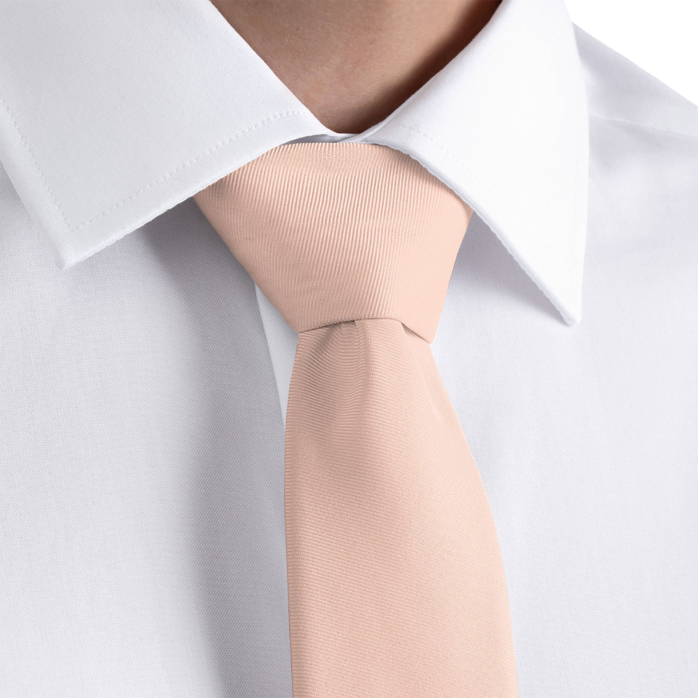 close up of a blush pink solid necktie