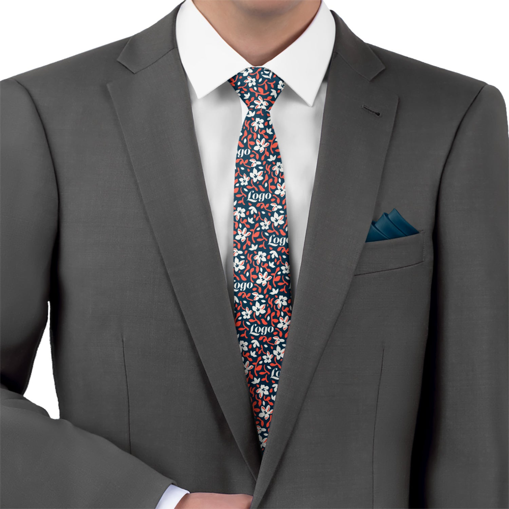 Man wearing a gray suit with a colorful patterned logo tie and blue pocket square.