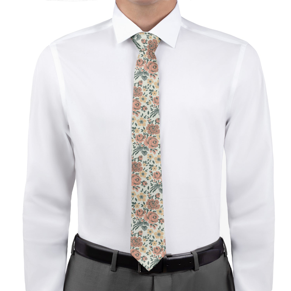 Person wearing a white shirt with a floral tie on a white background