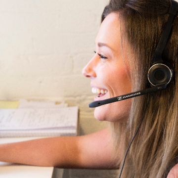 Woman wearing a headset smiling.