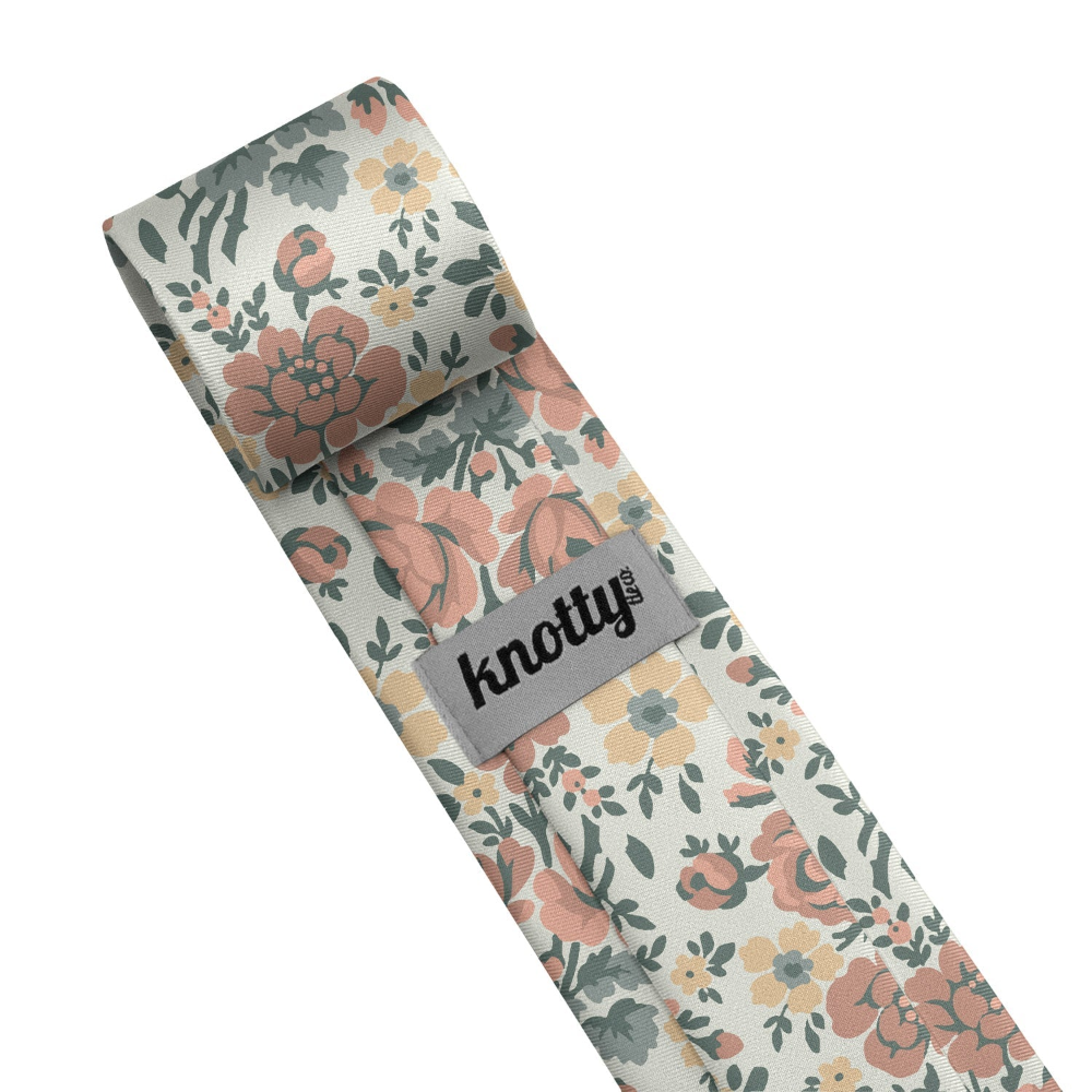 Floral-patterned tie with 'knotty' branding on a white background