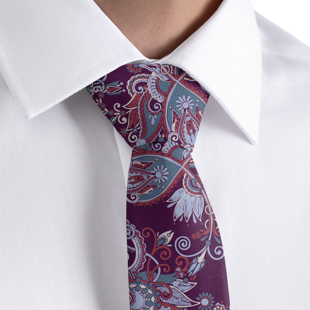 Close-up of a paisley patterned tie on a white shirt