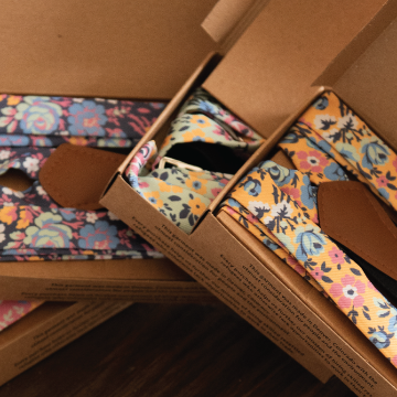 Four customized floral suspenders in gift packaging